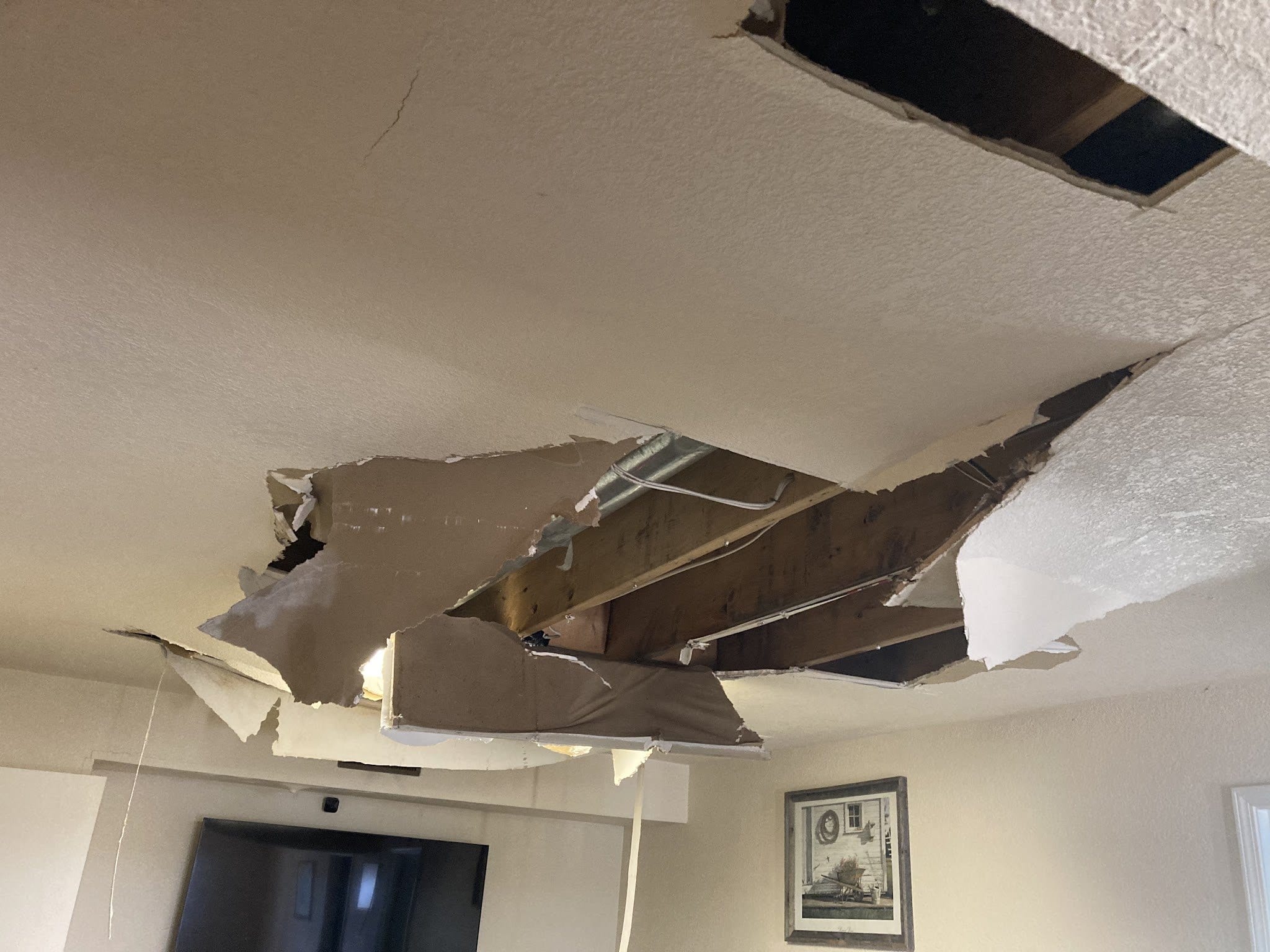 A ceiling collapsed by a water leak, opened up before drying begins